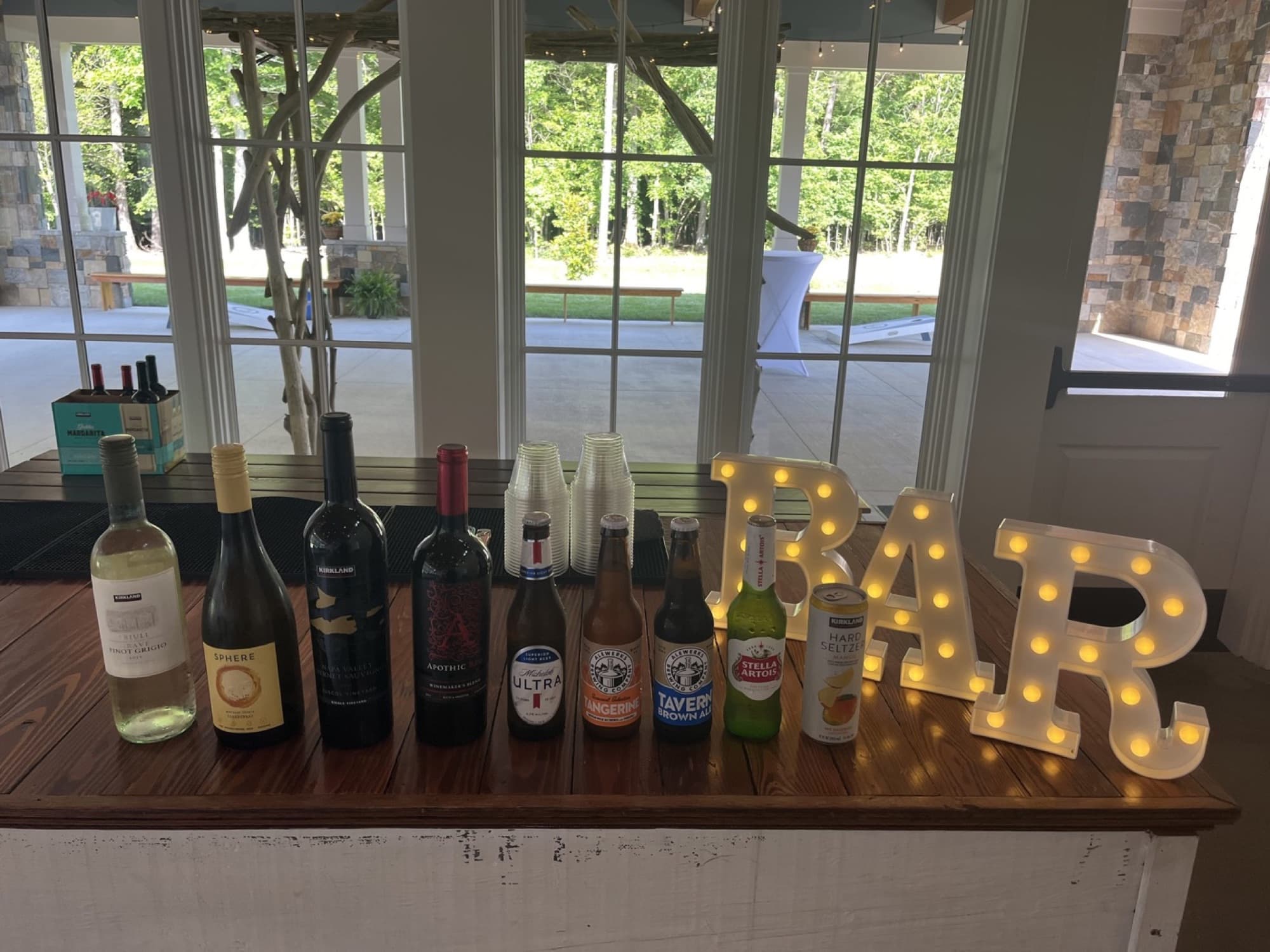 The Beer and Wine package set out and ready to pour, beside lit BAR letters.